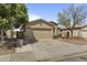 A well-kept single-story home featuring a two-car garage, mature landscaping, and a cozy front entrance at 2932 N 115Th Ln, Avondale, AZ 85392