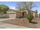 A single-story home featuring desert landscaping, a two-car garage, and a well-manicured front yard at 2932 N 115Th Ln, Avondale, AZ 85392