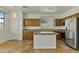 Beautiful kitchen with stainless steel appliances, tile backsplash, and a central island for meal prep at 2932 N 115Th Ln, Avondale, AZ 85392