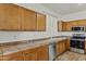 Stylish kitchen features stainless steel appliances, ample cabinet space, and tile countertops at 2932 N 115Th Ln, Avondale, AZ 85392
