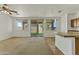 Open-concept living room connects to outdoor patio space with ceiling fan and ample sunlight at 2932 N 115Th Ln, Avondale, AZ 85392
