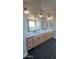 Modern primary bathroom with double sinks, quartz counters, and black tile shower at 31505 N 166Th Pl, Scottsdale, AZ 85262