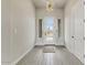 Inviting entryway featuring a modern door with sidelights, wood-look tile flooring, and stylish light fixture at 31505 N 166Th Pl, Scottsdale, AZ 85262