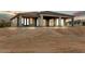 Rear exterior showcasing covered patio, neutral color scheme, and desert landscaping at 31505 N 166Th Pl, Scottsdale, AZ 85262
