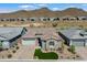 Aerial view of a modern home with a three-car garage and mountain views at 32268 N 133Rd Ln, Peoria, AZ 85383