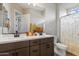 Bathroom with double sink vanity, modern fixtures, and decorative shower curtain at 32268 N 133Rd Ln, Peoria, AZ 85383