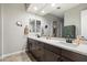 Elegant bathroom with dual sinks, vanity with storage, and a spacious mirror at 32268 N 133Rd Ln, Peoria, AZ 85383