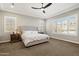 Cozy bedroom features plantation shutters, neutral walls, and a decorative ceiling fan, creating a peaceful retreat at 32268 N 133Rd Ln, Peoria, AZ 85383