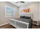 Cozy bedroom featuring a neutral color scheme, modern ceiling fan, and shuttered windows at 32268 N 133Rd Ln, Peoria, AZ 85383