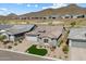 Beautiful two-story home featuring stone accents, a well-manicured lawn, and a mountain view at 32268 N 133Rd Ln, Peoria, AZ 85383