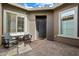 Charming front porch with seating area and brick-paved courtyard at 32268 N 133Rd Ln, Peoria, AZ 85383