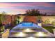 Inviting backyard featuring a modern hot tub with LED lights and desert landscaping at 32268 N 133Rd Ln, Peoria, AZ 85383