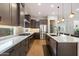 Bright kitchen featuring stainless steel appliances, a spacious island with a sink, and white subway tile backsplash at 32268 N 133Rd Ln, Peoria, AZ 85383