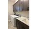 Functional laundry room with overhead cabinets, a utility sink, and modern washer and dryer at 32268 N 133Rd Ln, Peoria, AZ 85383