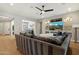 Comfortable living room with hardwood floors, a ceiling fan, and a large built-in entertainment center at 32268 N 133Rd Ln, Peoria, AZ 85383