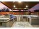 Under-cover outdoor kitchen featuring stainless steel appliances and a stone countertop at 32268 N 133Rd Ln, Peoria, AZ 85383