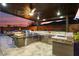 Beautiful covered outdoor kitchen featuring stainless steel appliances and a stone countertop at 32268 N 133Rd Ln, Peoria, AZ 85383