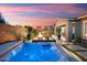 Backyard oasis with a hot tub, patio, firepit, and outdoor kitchen, perfect for entertaining at 32268 N 133Rd Ln, Peoria, AZ 85383