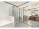 Bathroom featuring a glass shower and soaking tub at 3349 E Lavey Ln, Phoenix, AZ 85032