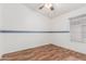 Bedroom with laminate floors, ceiling fan and a large window at 3349 E Lavey Ln, Phoenix, AZ 85032