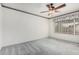 A bright bedroom with neutral carpet, ceiling fan, and window at 3349 E Lavey Ln, Phoenix, AZ 85032