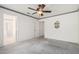 Spacious bedroom with a ceiling fan, carpet, and open doorways at 3349 E Lavey Ln, Phoenix, AZ 85032