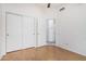 Bedroom with a ceiling fan, laminate floors, and closet at 3349 E Lavey Ln, Phoenix, AZ 85032