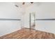 Bright bedroom featuring wood floors, ceiling fan, and closet with sliding doors at 3349 E Lavey Ln, Phoenix, AZ 85032