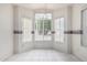 Bright dining area with large windows and tile flooring, and charming wallpaper trim at 3349 E Lavey Ln, Phoenix, AZ 85032
