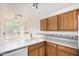 Well-lit kitchen featuring double sink, wood cabinets and spacious countertop at 3349 E Lavey Ln, Phoenix, AZ 85032