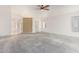 Spacious living room featuring plush carpeting, a ceiling fan, and ample natural light at 3349 E Lavey Ln, Phoenix, AZ 85032