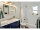 Bright bathroom with a blue vanity, modern fixtures, and a shower-tub combo, combining style and functionality at 3630 N 39Th St, Phoenix, AZ 85018