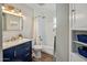 Bright bathroom with a blue vanity, modern fixtures, and a shower-tub combo, combining style and functionality at 3630 N 39Th St, Phoenix, AZ 85018