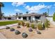 Beautifully landscaped front yard featuring desert plants, green grass and a private seating area at 3630 N 39Th St, Phoenix, AZ 85018