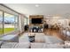 Spacious living room with large windows, wood accent wall, and seamless flow into the dining and kitchen areas at 3630 N 39Th St, Phoenix, AZ 85018