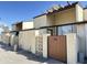 Beige two story home with modern wooden gate at 3646 N 69Th Ave # 70, Phoenix, AZ 85033