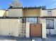 Beige two story home with modern wooden gate and AC units at 3646 N 69Th Ave # 70, Phoenix, AZ 85033