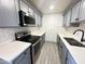 Renovated kitchen with gray cabinets, stainless steel appliances, and white counters at 3646 N 69Th Ave # 70, Phoenix, AZ 85033