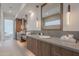 Elegant bathroom featuring double sinks, wooden cabinets, quartz countertops and modern pendant lighting at 37200 N Cave Creek Rd # 1019, Scottsdale, AZ 85262