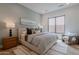 Bright bedroom featuring a plush bed, neutral decor, a modern window and a sitting area at 37200 N Cave Creek Rd # 1019, Scottsdale, AZ 85262