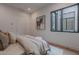 Bright bedroom featuring a plush bed, neutral decor, a modern window and an interesting donkey artwork at 37200 N Cave Creek Rd # 1019, Scottsdale, AZ 85262