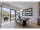 Bright dining room featuring a dark wood table, statement light fixture, and sliding glass doors to the patio at 37200 N Cave Creek Rd # 1019, Scottsdale, AZ 85262