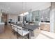 Open-concept dining area showcasing the kitchen and a stone fireplace with wine storage and modern light fixture at 37200 N Cave Creek Rd # 1019, Scottsdale, AZ 85262