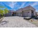 Stunning desert home featuring a modern design, neutral tones, and a spacious driveway with desert landscaping at 37200 N Cave Creek Rd # 1019, Scottsdale, AZ 85262