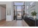Modern foyer featuring hardwood floors, a console table, and a view through glass doors to desert landscaping at 37200 N Cave Creek Rd # 1019, Scottsdale, AZ 85262