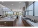Open-concept kitchen with stainless steel appliances, island seating, and a seamless transition to dining and living spaces at 37200 N Cave Creek Rd # 1019, Scottsdale, AZ 85262