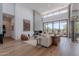Bright living room features a stone fireplace, comfortable seating and seamless access to the outdoor patio at 37200 N Cave Creek Rd # 1019, Scottsdale, AZ 85262