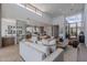 Open-concept living room with high ceilings, modern furnishings, and seamless access to the kitchen and dining area at 37200 N Cave Creek Rd # 1019, Scottsdale, AZ 85262
