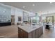 Bright, open-concept living space with a fireplace, modern decor, and kitchen with island seating nearby at 37200 N Cave Creek Rd # 1019, Scottsdale, AZ 85262