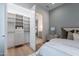 Bedroom featuring ensuite bathroom and walk-in closet, hardwood floors and blue accent wall at 37200 N Cave Creek Rd # 1019, Scottsdale, AZ 85262